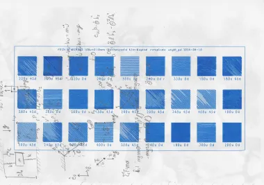 Blue ballpoint calibration chart with a matrix of line densities and angles over engineering notes.